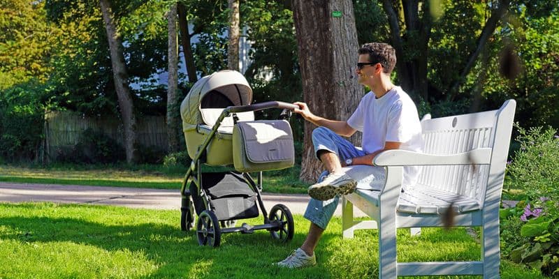 Padre con bebé sentado en un parque